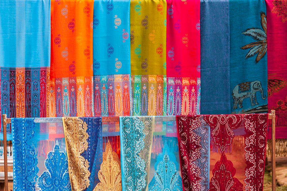 Laos- Luang Prabang. Colorful textiles- possibly scarves- for sale.